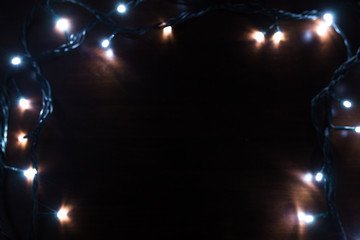 Christmas garland closeup on wooden background
