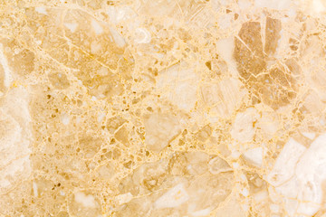 Light marble texture background. Natural marble stone texture in warm colors. Background with small waves and a round pattern. Orange, gold, yellow and beige shades.