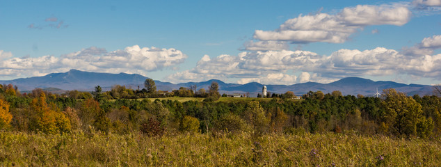 panorama of rural Vermont farm with the Green Mountains in the background