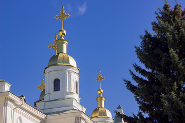 Fototapeta na wymiar orthodox crosses on gold domes (cupolas) againts blue sky