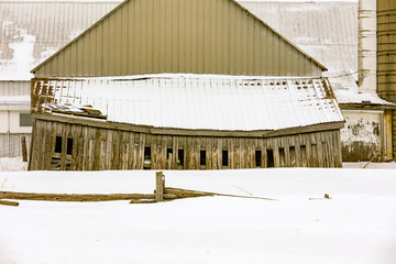 Antique barn in a snowy winter scene in rural Quebec, Canada.