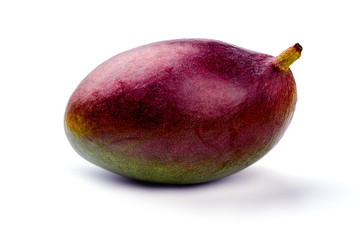 Close up fresh organic mango on light background. Tasty tropical fruit close up. Delicious exotic fruit.