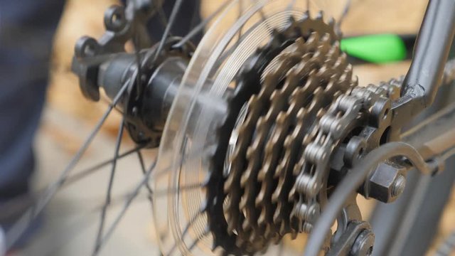 speed bike rear sprocket. high-speed bicycle, rear sprocket against the background of a spinning wheel