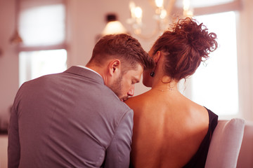 The picture of elegant couple who are very close.