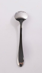 Metal spoon for sugar in the shape of skull
