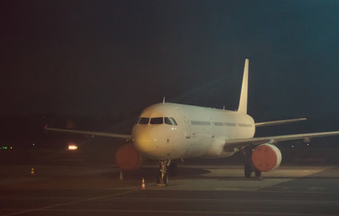 Fototapeta na wymiar Commercial passenger plane at night airport.