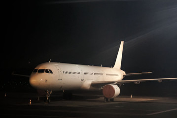 Commercial passenger plane at night airport.