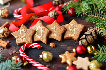 christmas cookies in the shape of stars decor gold lettering 2019, with candy,  tree and pine cones, and  balls yellow and red, Christmas 2019, new year is 2019, selective focus