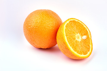 Fresh ripe oranges on light background. Whole and half of orange fruit. Healthy eating concept.