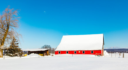 Antique barn in rural Quebec Canada after a snow storm.
