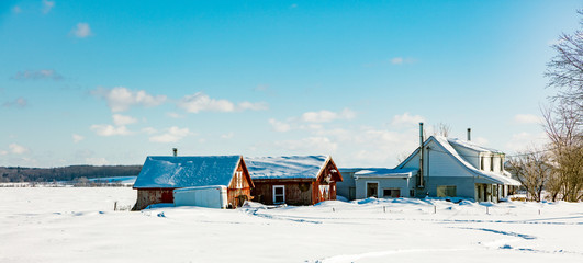 Antique barn in rural Quebec Canada after a snow storm.