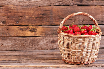 Juicy strawberries in basket and copy space. Wicker basket full of fresh ripe strawberries and text...