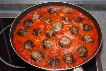 Meatballs meat in a frying pan
