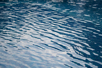 Waves on blue water surface in swimming pool