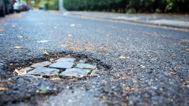 pothole on small street,