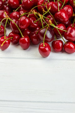 Heap of ripe cherries and copy space. Fresh delicious berries on white background. Reasos to eat cherries.
