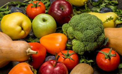 fresh fruits and vegetables on a dark wooden background