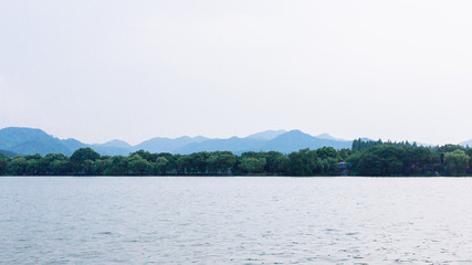 View of West Lake, with islands and hills in the distance, in Hangzhou, China