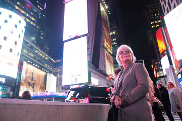 Mature woman with white hair visiting Times Square in New York Cith