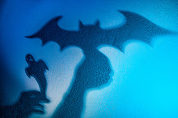 Shadow play. The shadow of a bat. Reflection shadows on the wall. Halloween Vampires.