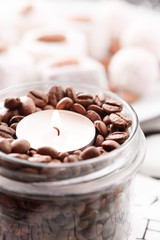 Glass jar with coffee bean and candle