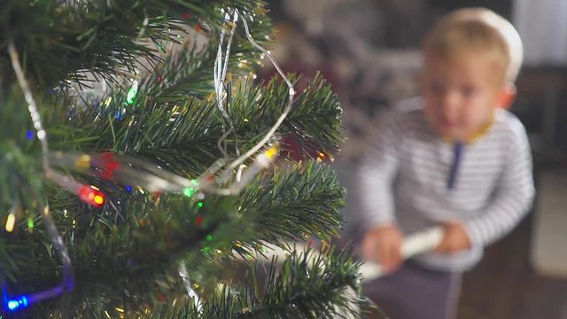 boy playing with a donated bike near Christmas tree