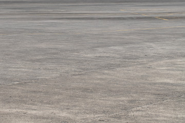Empty asphalt airport space. Grunge asphalt perspective photo. Sunny faded grey asphalt background.