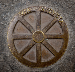 metallic symbol of the Via Augusta on the floor