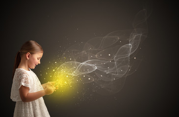 Little cute girl playing on sparkling tablet
