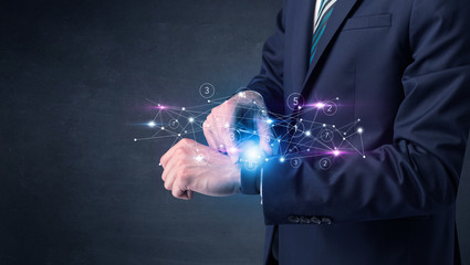 Man wearing smartwatch with networking concept on it.