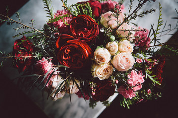 Red and Peach Roses in Gold Vase on Marble