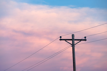 Telegraph pole and wires at sunset