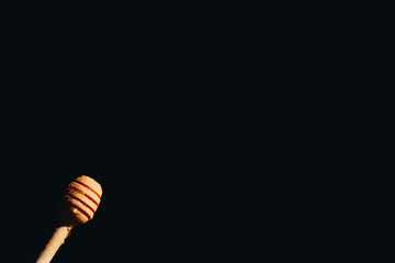 jar of honey with bagels on wooden table close up with honey dipper