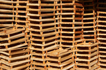 Empty wooden crate for fruits and vegetables stacked in a market warehouse, close-up. Wooden boxes background, outdoors