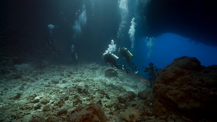 Fototapeta na wymiar scuba divers inside underwater cavern
