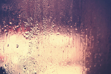 Wet window glass with melting frozen water. 