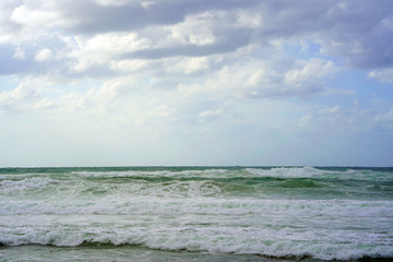 Beautiful wave on the beach. Early morning and strong wind. Cloudy morning.