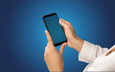 Mockup for female hand using frameless smartphone with dark background
