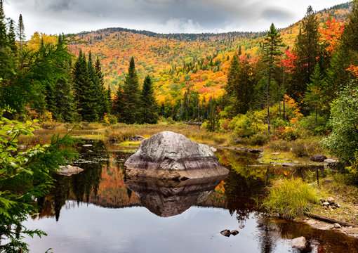 Fall colors of Lac Legault with Mont Kaaikop in the background, in cottage country in the Laurentians, Quebec, Canada.