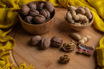 Walnuts kernels on dark desk with color background, Whole walnut in wood vintage bowl, Nuts in bamboo wooden bowl, walnuts in wood bamboo bowl