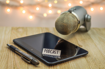 Fototapeta na wymiar Podcast concept with mic and black shiny tablet