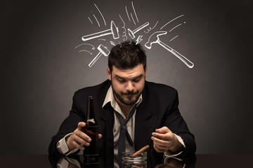 Young drunk disappointed man with hangover concept
