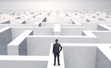 Small businessman in a middle of a huge maze
