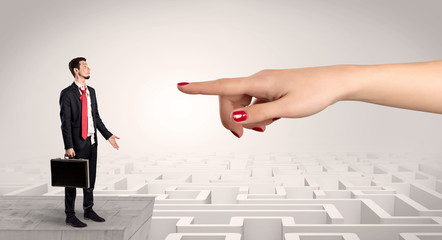 Young businessman blindly in love in the middle of an infinity maze concept
