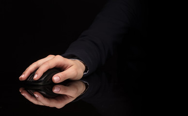 Hand using wireless mouse in a dark environment
