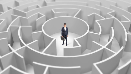 Young businessman standing in a middle of a 3d round maze
