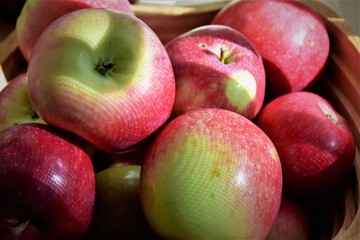 Fototapeta na wymiar Organic red apples in wooden plate.Moldova