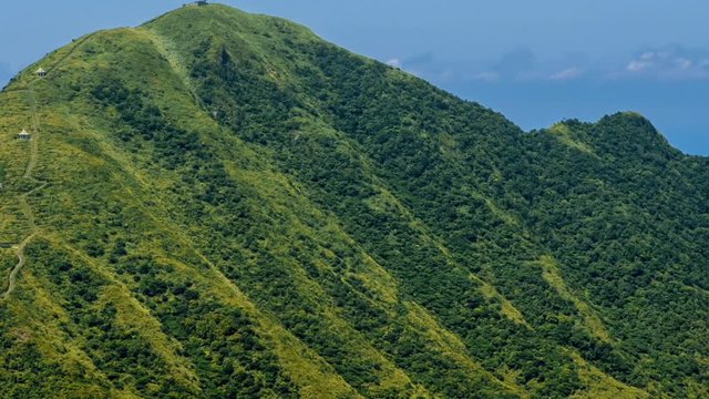Timelapse of Keelung mountain with blue sky in New Taipei city. Beauty Hyperlapse of landscape of green mountains with long stairs and chinese pavilion. Scenic of a beautiful summer day in Jishan-Dan