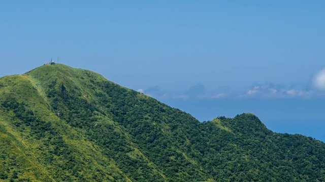 Timelapse of Keelung mountain with blue sky in New Taipei city. Beauty Hyperlapse of landscape of green mountains with long stairs and chinese pavilion. Scenic of a beautiful summer day in Jishan-Dan