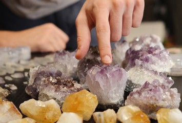 Beautiful, bright tumbled crystal chips. Stunning healing crystals. Macro photograph, low exposure. Hand holding crystals, bright healing crystals. Crisp colors and lighting, clear quartz, opalite